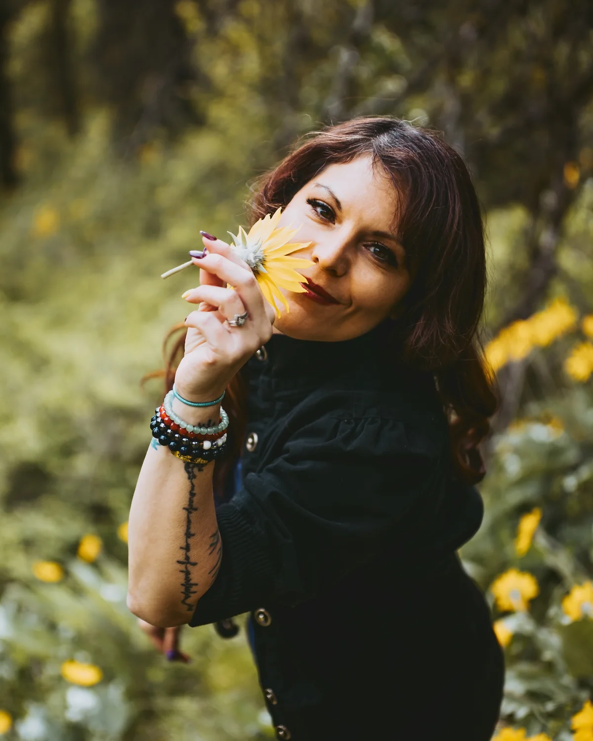 Lacy Watson, founder of Morning Moon Digital Media + Coaching, holding a yellow flower